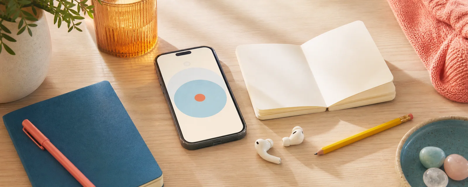 Phone, notebook and practical tools arranged for an approachable wellbeing exercise